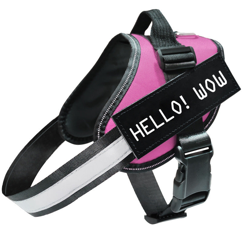 Pink dog harness with a black label saying &