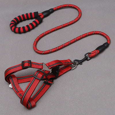 Red and black dog harness and leash set on a gray background