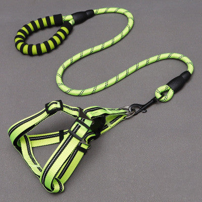 Green and black dog harness and leash set on a gray background